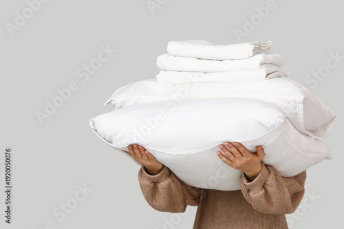 Young woman holding stack o...