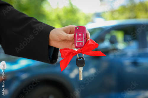 Female hand with gift keys ...