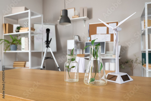 Lab flasks with green leave...