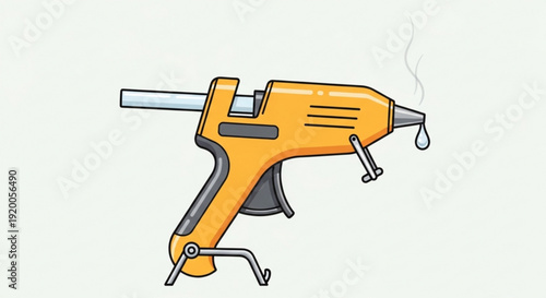 Yellow hot glue gun with metal nozzle and stand isolated on light gray background