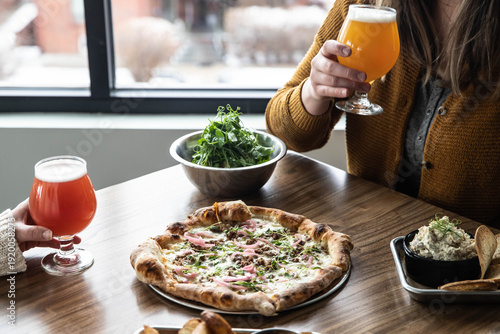 Wallpaper Mural Casual restaurant dining with pizza, beer, and fries Torontodigital.ca