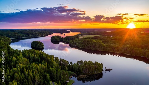 Sunset over lake and forest reflecting in water