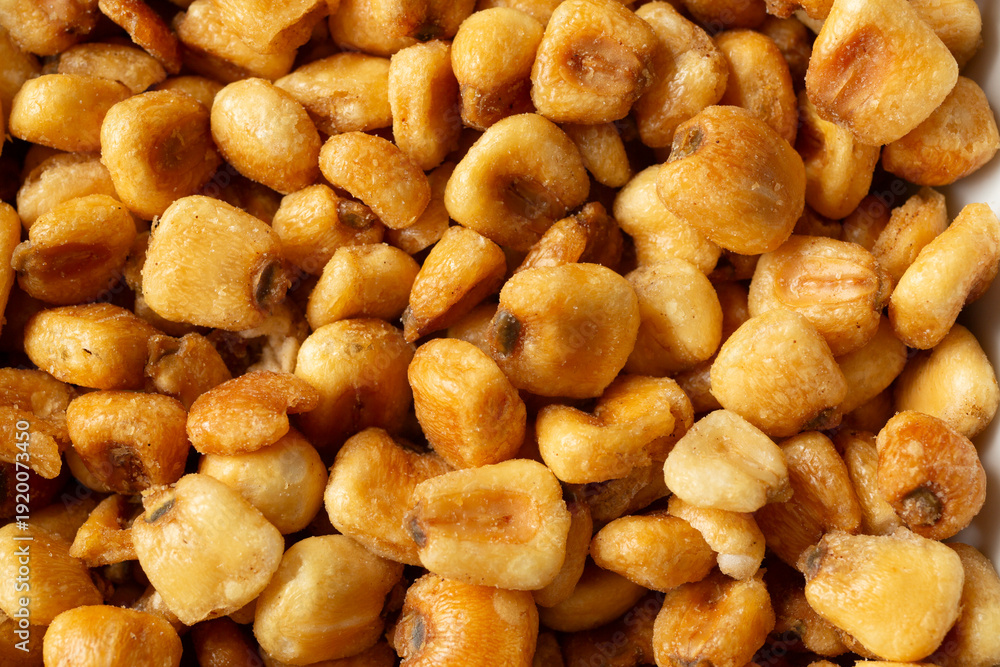 Fototapeta premium A top down view of a pile of corn kernel snacks, as a background.