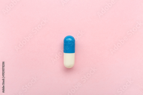 Medical capsule on pink bac...