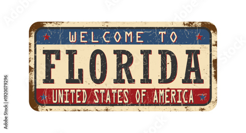 Welcome to Florida. An old worn sign with an inscription. Welcome metal plaque with rust elements