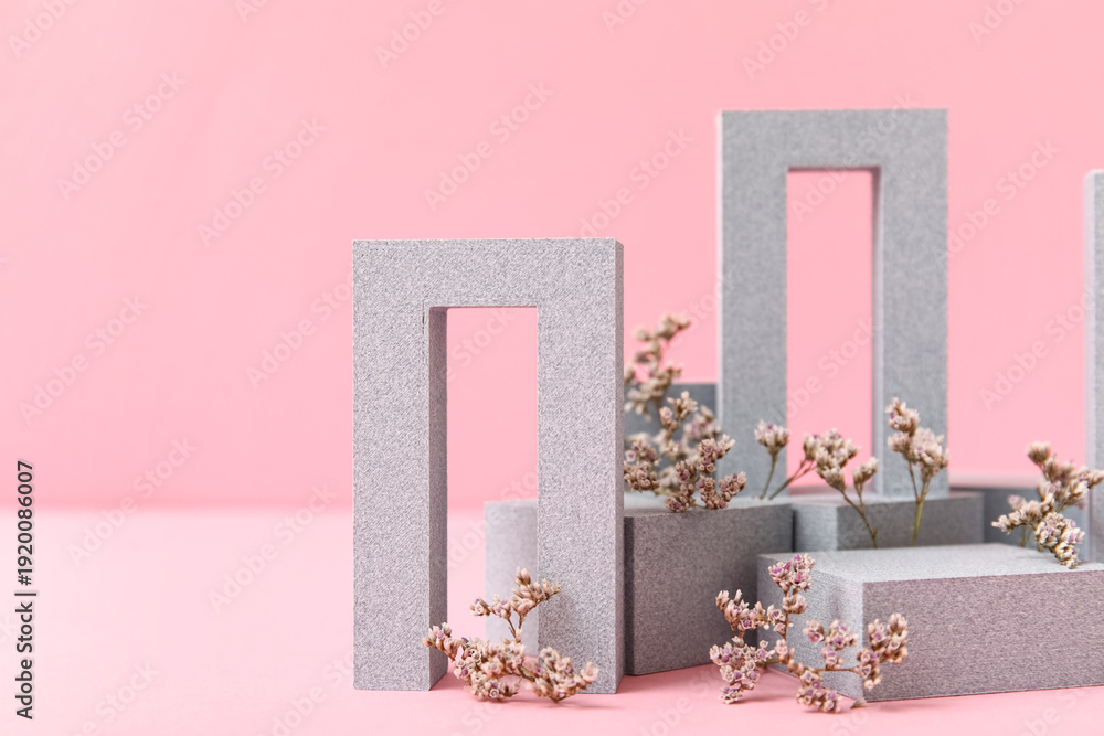 Naklejka premium Decorative plaster podiums with gypsophila flowers on pink background