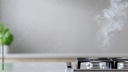 A close-up of a gas stove with faint smoke rising, set against a clean, modern kitchen background