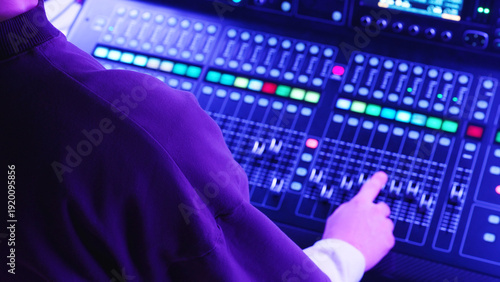 Professional Sound Engineer Adjusting Audio Levels, Controlling Mixing Console Backstage. Live Music Concert, Music Festival, Production Concept