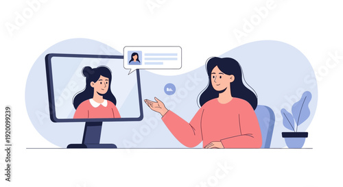 Woman chatting with another woman on a computer screen in a modern office setting.