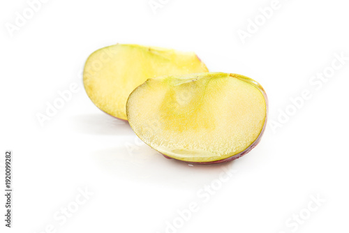 фотографія Fresh Sliced Fuji Apple with Yellow Flesh and Heart Core on White Background