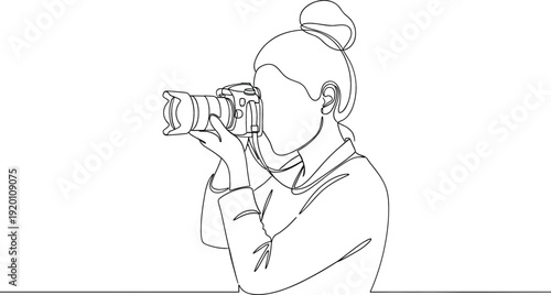 Continuous one line drawing of a female photographer holding a professional camera for creative media concept