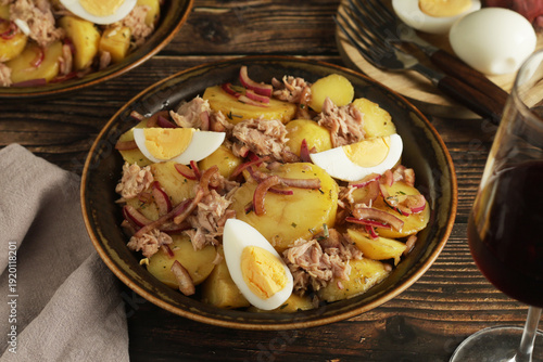 A bowl with Patatas alinadas traditional Spanish Salad in rustic style