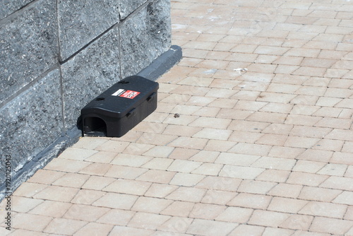 Trap and rodent bait station placed along the wall of the building. Devices for monitoring the presence and control of rodents.