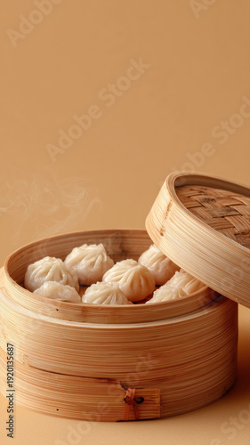 Bamboo Steamer with Dim Sum Dumplings Isolated on Beige Background