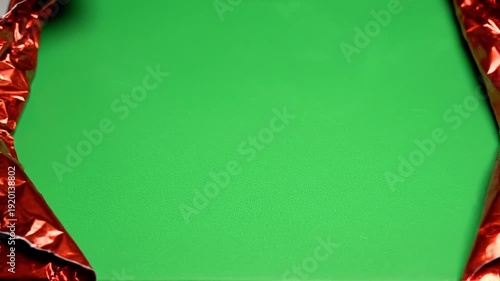 Red Gift Wrap Tearing Open to Reveal Green Screen Background