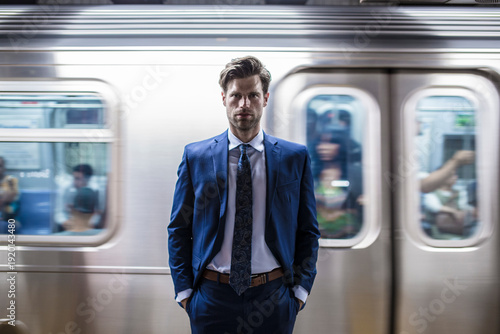 Businessman standing in front of leaving metro train