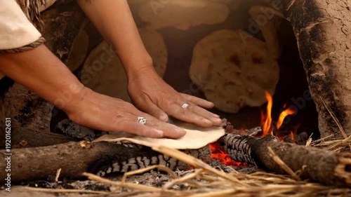 An ancient clay oven with flatbreads baking inside. The scene captures a traditional method of cooking from biblical times, emphasizing historical culinary practices.