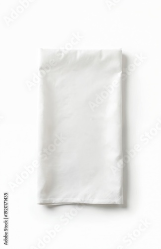 Plain white cotton napkin is neatly folded. This textile lies on a bright white background. It is suitable for culinary use in restaurants or home.