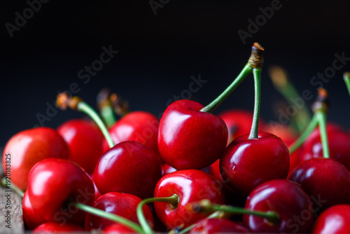 Φωτογραφία Fresh cherries filling the frame, dark moody lighting