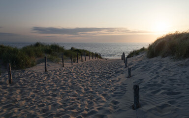 Foto auf Acrylglas Nordsee Dusk over the North Sea sandy beach from the top of the path on the dune in Zandvoort, Netherlands  © Matt A. Hawk