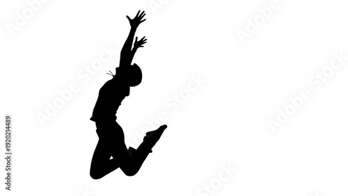 Silhouette of a person jumping high in the air with arms outstretched.