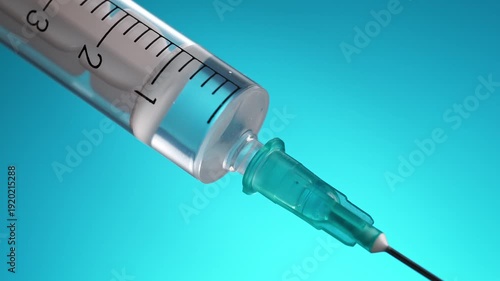 Giving Injection Or Vaccine With a Medical Disposable Syringe With Needle In Macro on a Light Blue Background