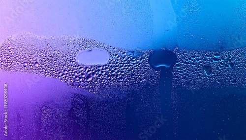 Condensation on a glass surface with vibrant purple and blue light creating an abstract texture background