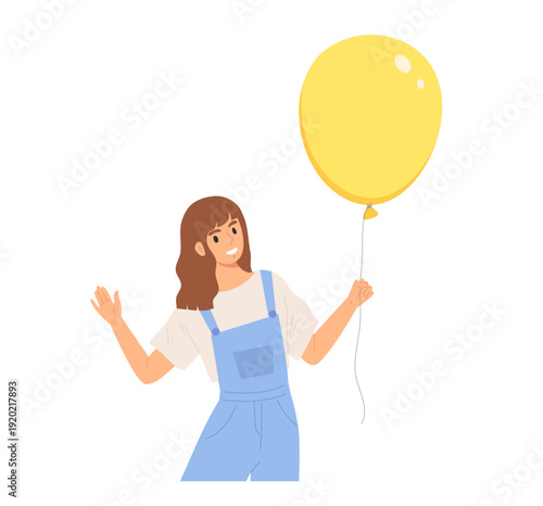 Fotografia Young cheerful female standing and holding bright yellow balloon