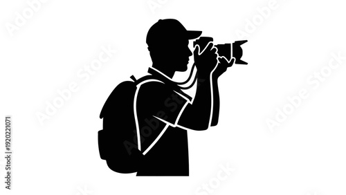 Silhouette of a photographer taking a photo with a camera.