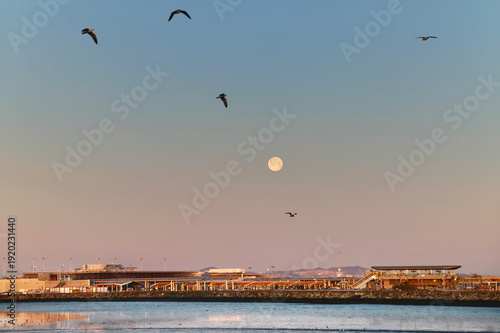 Full moon sunrise over the San francisco bay oakland airport, california