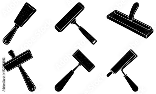 Collection of paint rollers in various orientations on a clean background viewed from directly above