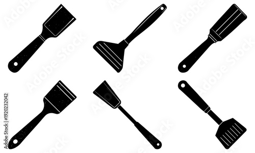 Collection of various kitchen utensils with distinct shapes and sizes arranged together on a clean background