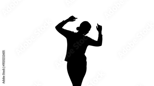 Silhouette of a woman dancing with arms raised.