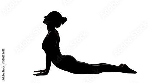 Silhouette of a woman performing a yoga cobra pose.