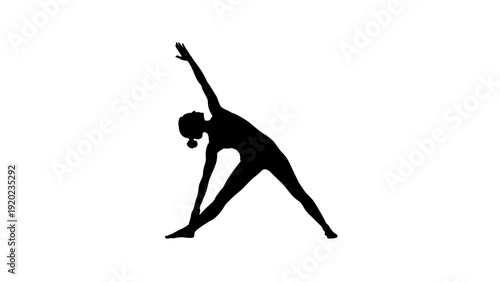 Silhouette of a woman performing a yoga triangle pose.