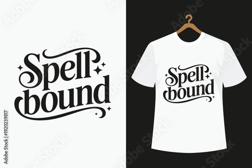 White T- Shirt with Black Spellbound Text Hanging on a Wooden Hanger white t-shirt black text stylized font