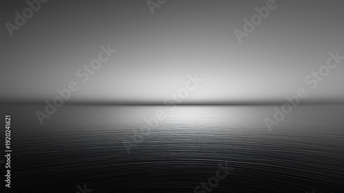 静かな海面のモノクロ風景。背景素材やデザイン用の抽象的なイメージ。