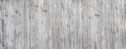 Gray concrete wall showing weathered wood grain texture