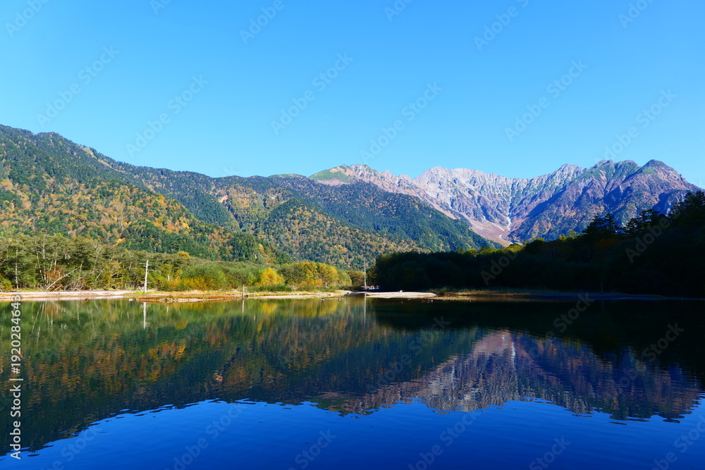 Fototapeta premium 大正池に映る秋の穂高連峰。上高地、松本、長野、日本。10月下旬。
