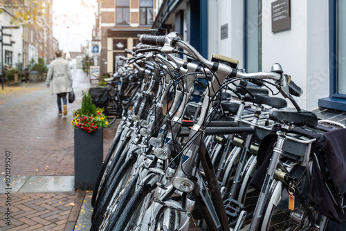Closeup view many red city bikes parked in row at Dutch Hattem city street rental parking sharing station or sale. Healthy ecology urban transportation. Sport environmental transport infrastructure