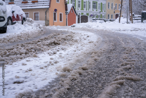 Slushy, unsalted and unplowed city street after heavy snowfall in winter. Snow chaos in Baden near Vienna, Austria