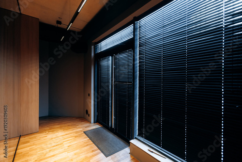 Bilde på lerret Private space featuring shadowed windows and wooden flooring