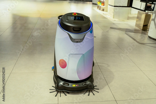 Automatic vacuum and sweeping robot are working inside the mall.