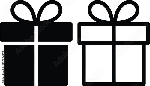 Two black gift boxes tied with ribbons sitting side by side on a plain background