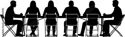 Silhouette of professional business people sitting in a row at a long table during a corporate meeting or conference
