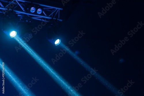 Wallpaper Mural Blue spotlights cast dramatic beams through haze over a concert stage truss, creating a moody atmosphere for live music, performance and entertainment production Torontodigital.ca