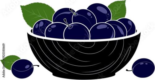 A wooden bowl filled with dark blue plums and green leaves on a white background
