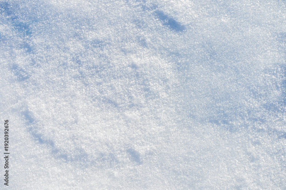 Fototapeta premium Natural snow surface texture with soft light and subtle shadows. Winter background with copy space, minimal seasonal backdrop. 