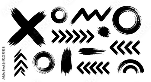 Abstract black grunge brush strokes and shapes set on white background.