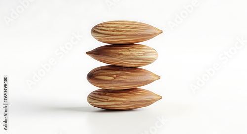 Stack of four brown almonds isolated on white background healthy snack food